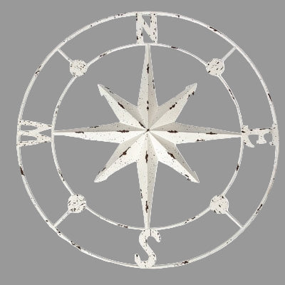 Decorative compass wall art with a white distressed finish on a white background
