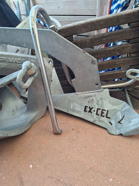 Metal anchor with 'Ex-Cel' branding on a wooden surface 47 pounds