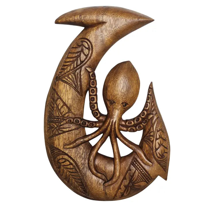Wooden carvings of an octopus and crescent moon with intricate patterns on a white background