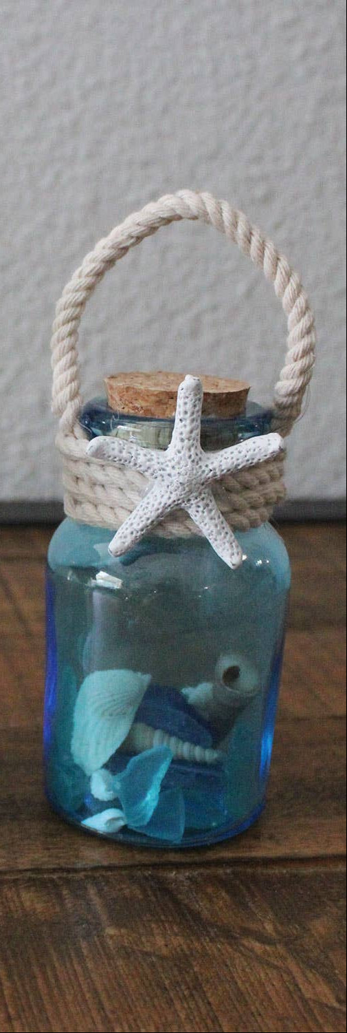 Decorative bottle with starfish and cork lid on a wooden surface