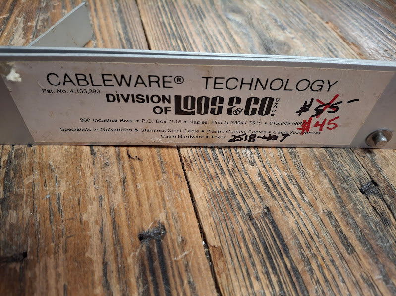 Metal tension gauge back view with 'Cableware Technology' branding on a wooden surface