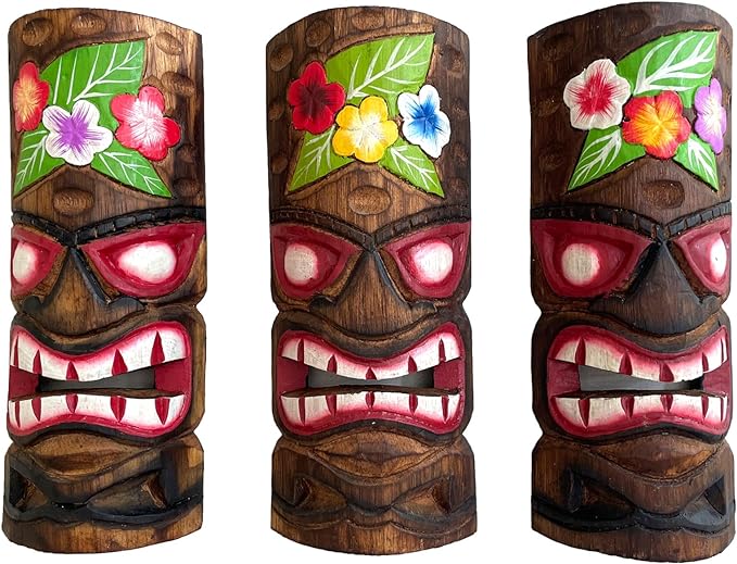 Three wooden tiki masks with floral designs on a white background