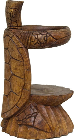 Carved wooden bottle holder shaped like a turtle holding the bottle